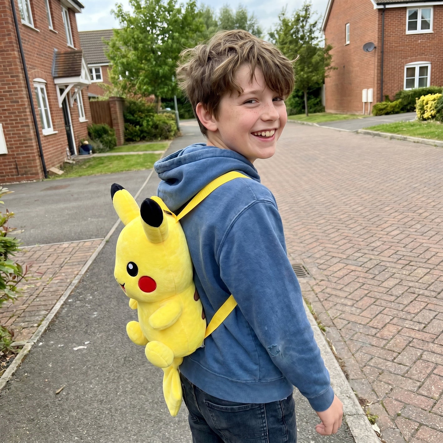 Young boy wearing his Pokemon plush backpack